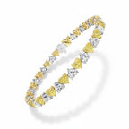 My Store 4 tennis bracelet featuring alternating fancy yellow and white heart-cut diamonds in two-tone gold settings.