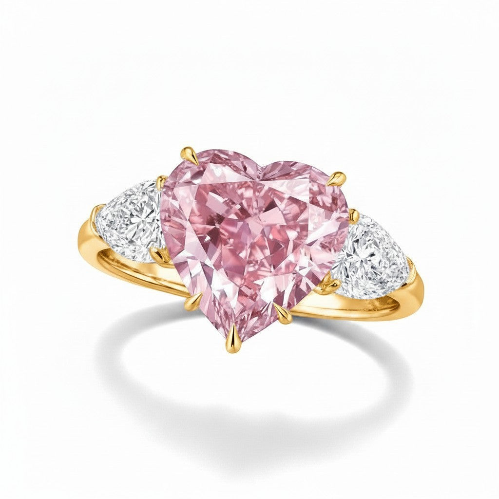 My Store 4 18K gold trilogy ring featuring a heart-cut fancy pink lab-grown diamond with two side pear-cut diamonds.