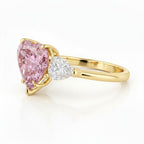 My Store 4 18K solid gold trilogy ring featuring a heart-cut fancy pink lab-grown diamond and side accent stones.