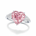 My Store 4 18K solid gold trilogy ring featuring a heart-cut fancy pink lab-grown diamond and side accent stones.