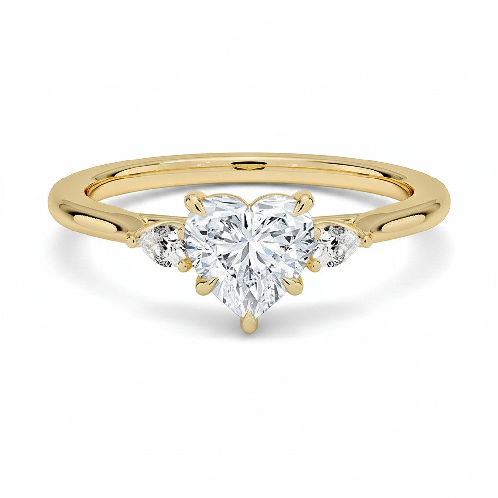 My Store 4 18K solid gold trilogy ring featuring a heart-shaped lab-grown diamond flanked by two pear-cut diamonds.