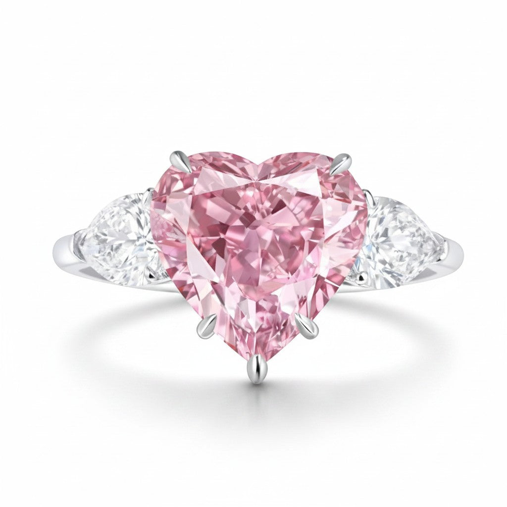 My Store 4 18K solid gold trilogy ring featuring a heart-cut fancy pink lab-grown diamond with pear-cut side stones.