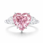 My Store 4 18K solid gold trilogy ring featuring a heart-cut fancy pink lab-grown diamond with pear-cut side stones.