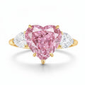 My Store 4 18K gold trilogy ring featuring a heart-cut pink lab-grown diamond flanked by two white side diamonds.