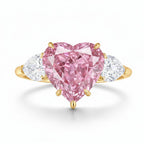 My Store 4 18K gold trilogy ring featuring a heart-cut pink lab-grown diamond flanked by two white side diamonds.