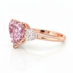 My Store 4 18K rose gold trilogy ring featuring a heart-cut fancy pink lab-grown diamond and pear-cut side stones.