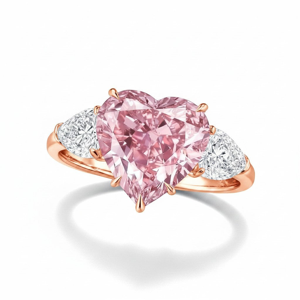 My Store 4 18K rose gold trilogy ring featuring a heart-cut fancy pink lab-grown diamond and two side diamonds.