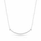 My Store 4 large smile diamond necklace in polished white gold with a curved bar and T-bar ends on a trace chain