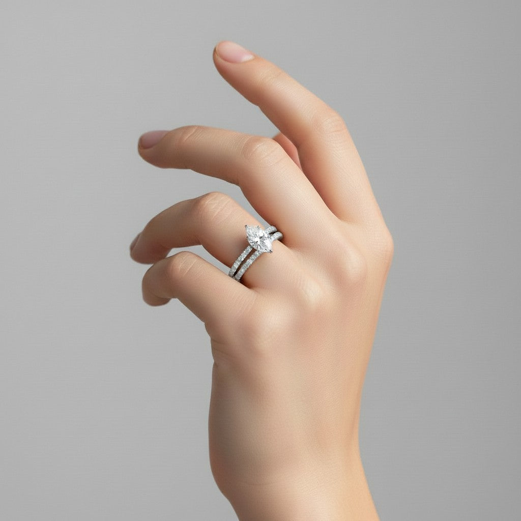 My Store 4 marquise diamond engagement ring and matching pavé wedding band set worn on a woman's finger.