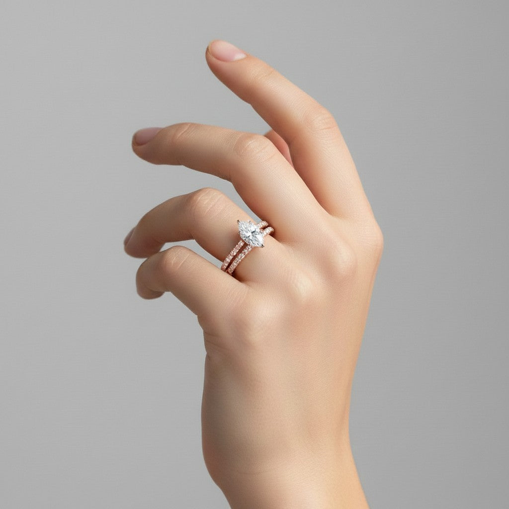 My Store 4 marquise diamond engagement ring and matching pavé wedding band set worn on a woman's finger.