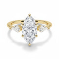 My Store 4 18K solid gold trilogy ring featuring a central marquise-cut lab-grown diamond with two pear-cut side stones.