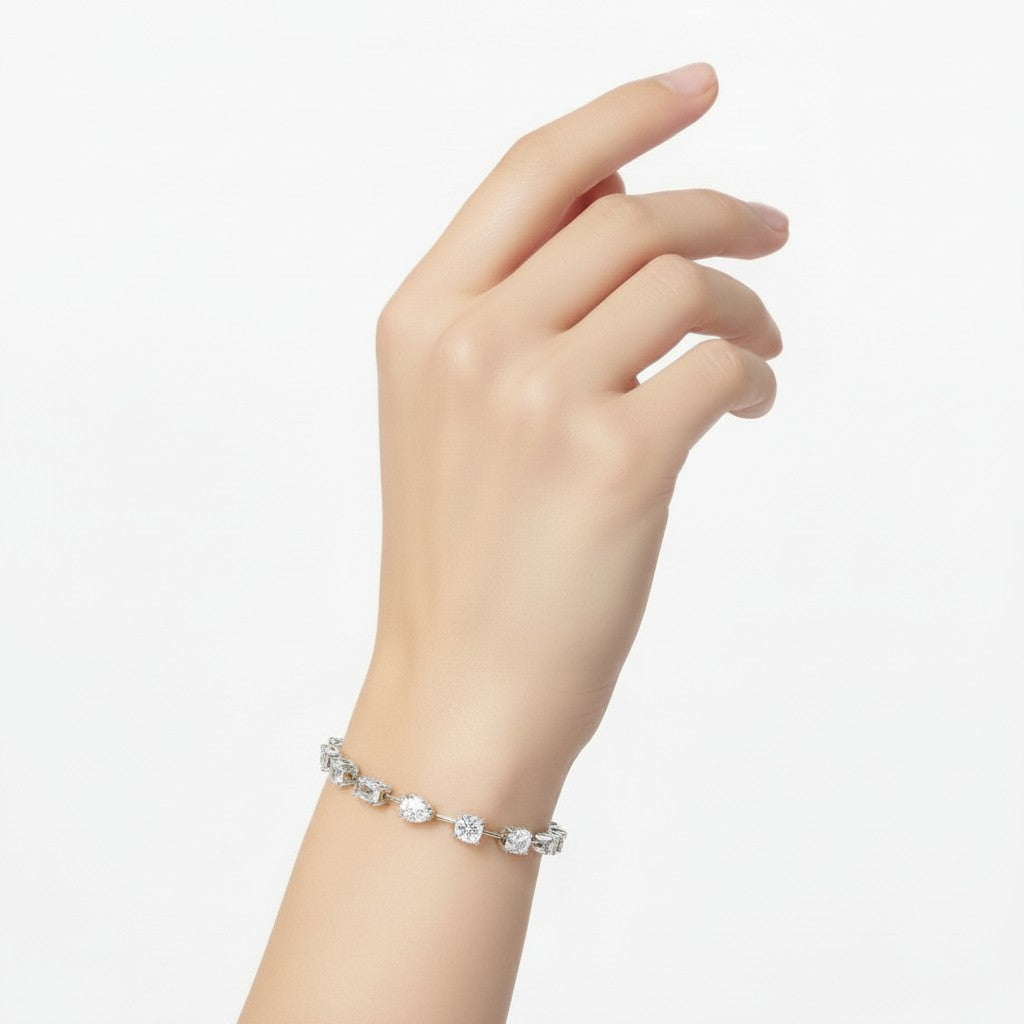 My Store 4 tennis bracelet featuring mixed fancy cut diamonds in gold, worn on a woman's wrist.