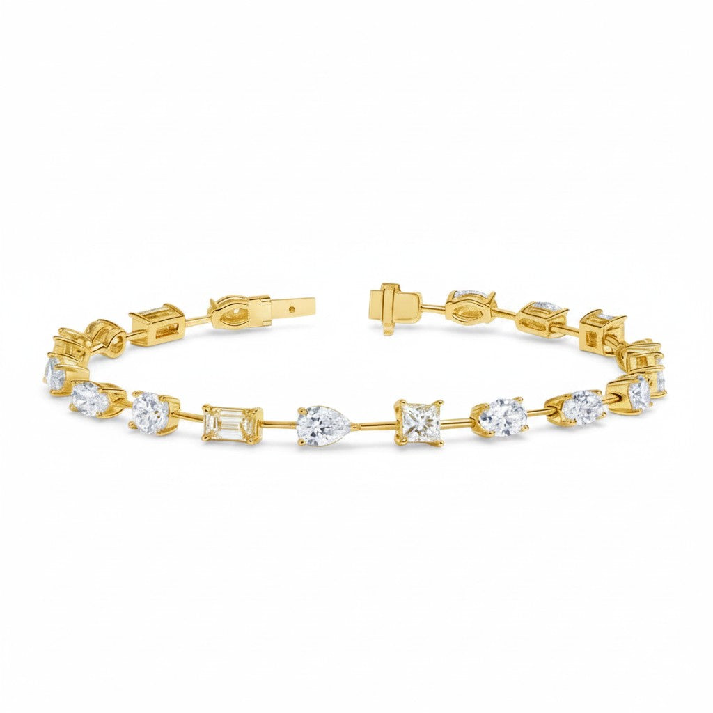 My Store 4 gold tennis bracelet featuring a mix of pear, emerald, princess, oval, and round cut diamonds in baskets.