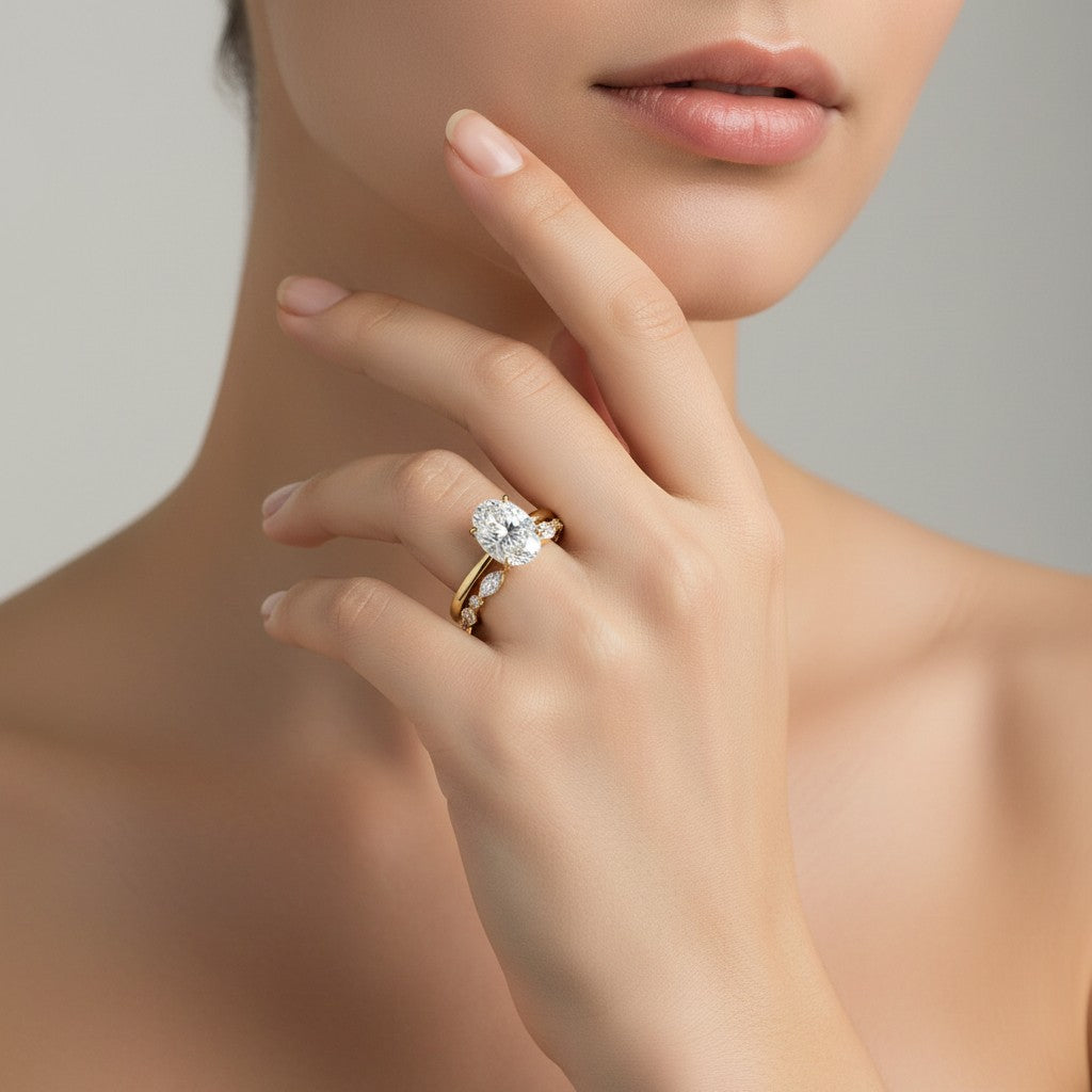 My Store 4 18K solid gold bridal set with a 1.5ct oval lab-grown diamond and marquise accent stones on a woman's hand