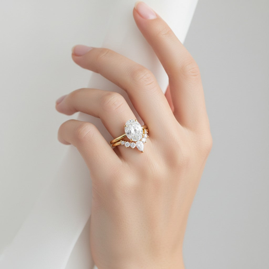 My Store 4 18K gold bridal set featuring a 1.5ct oval lab-grown diamond solitaire and a pear-accented contour band.