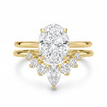 My Store 4 18K solid gold bridal ring set with a 1.5ct oval lab-grown diamond and pear-shaped accent stones.