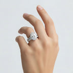 My Store 4 oval diamond halo engagement ring and matching eternity wedding band set worn on a woman's finger.