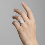 My Store 4 18K solid gold oval diamond halo ring worn on a woman's finger, featuring a vintage-inspired design.