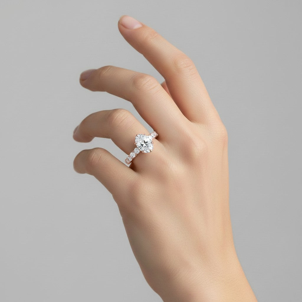 My Store 4 18K solid gold oval lab-grown diamond engagement ring set with pavé band worn on a woman's hand