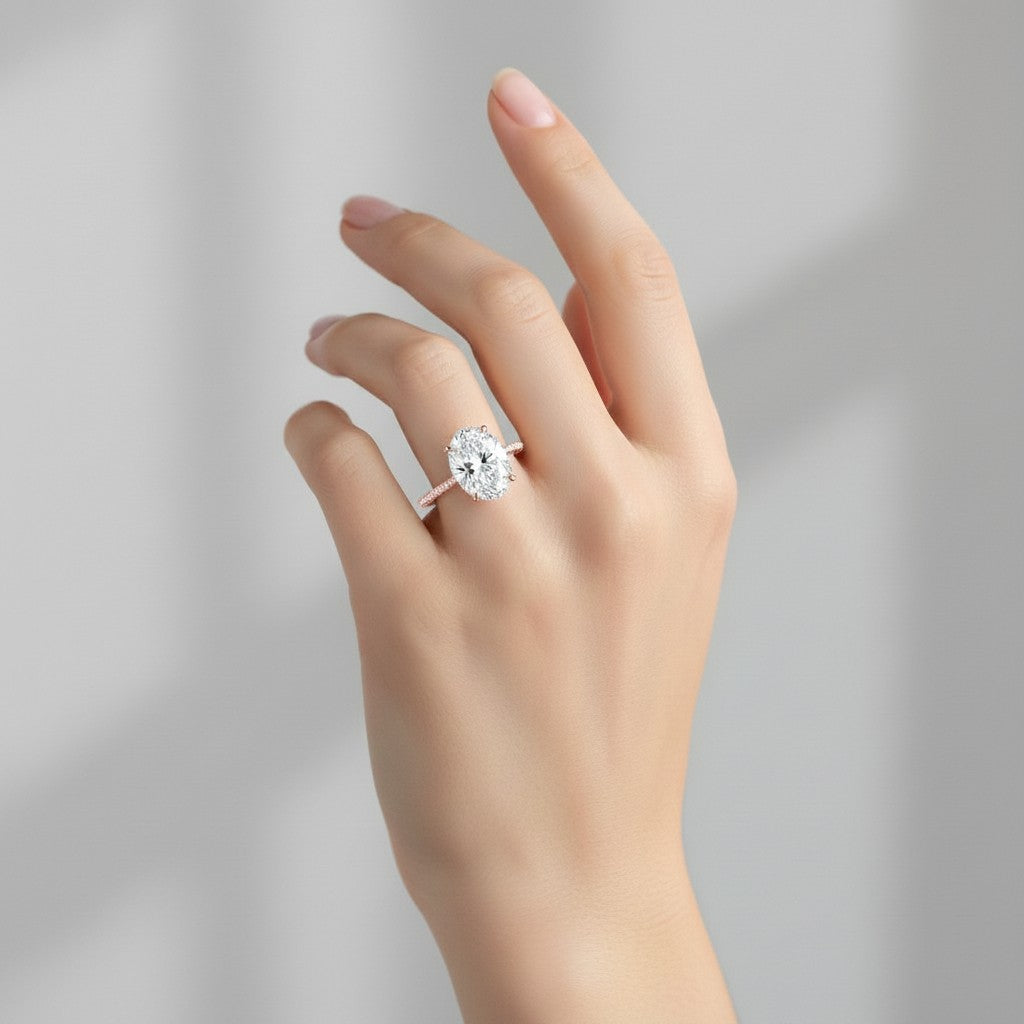 My Store 4 18K white gold oval lab-grown diamond engagement ring with a hidden halo and pavé band on a hand