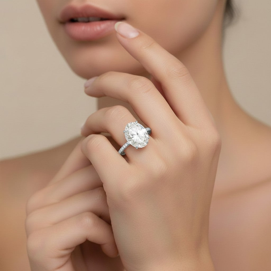 My Store 4 18K white gold oval lab-grown diamond engagement ring with a hidden halo and pavé band on a woman's finger