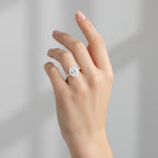 My Store 4 18K white gold oval lab-grown diamond engagement ring with a hidden halo and pavé band on a hand.
