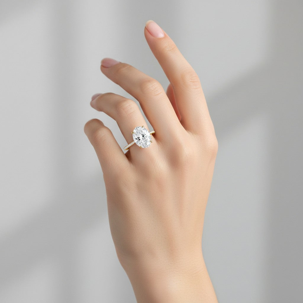 My Store 4 18K white gold oval lab-grown diamond engagement ring with a hidden halo and pavé band on a hand.