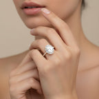 My Store 4 18K white gold oval lab-grown diamond engagement ring with a hidden halo and pavé band worn on a finger