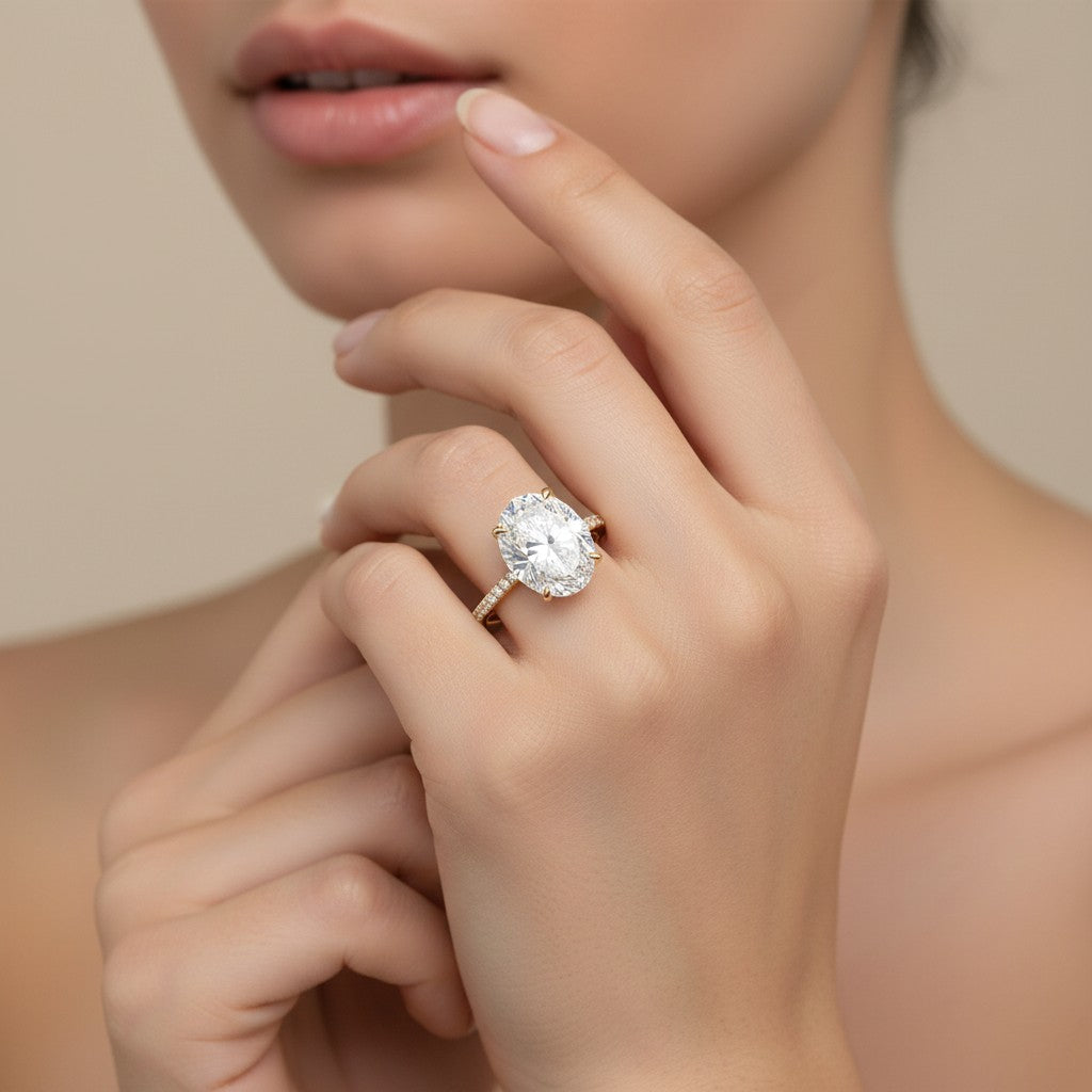 My Store 4 18K white gold oval lab-grown diamond engagement ring with a hidden halo and pavé band worn on a finger