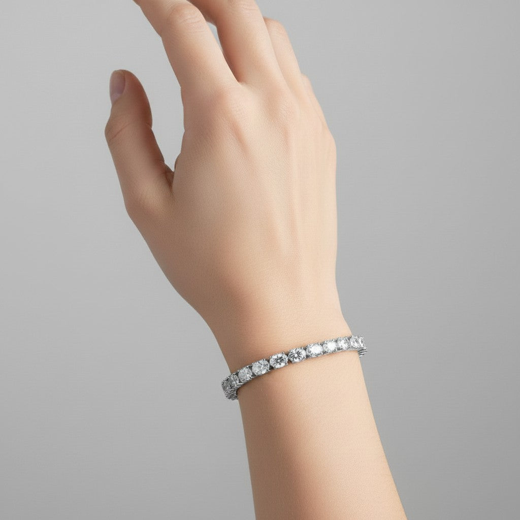 My Store 4 east-west oval diamond tennis bracelet in white gold worn on a woman's wrist against a neutral background.