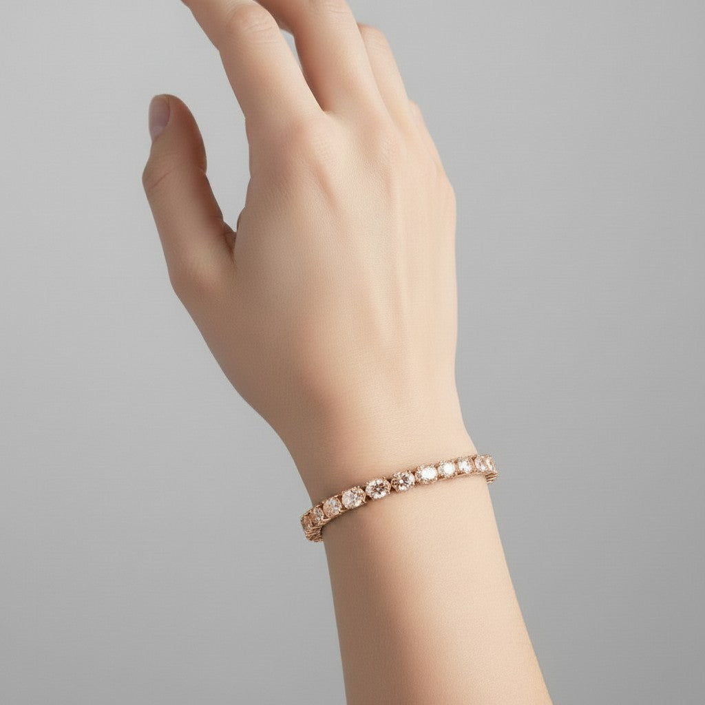 My Store 4 East-West oval cut diamond tennis bracelet in rose gold worn on a woman's wrist