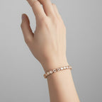 My Store 4 East-West oval cut diamond tennis bracelet in rose gold worn on a woman's wrist