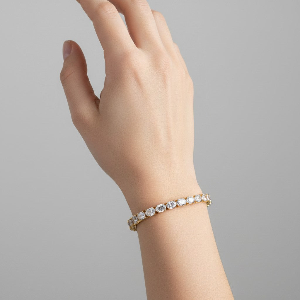My Store 4 East-West oval cut diamond tennis bracelet in yellow gold worn on a woman's wrist