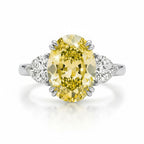 My Store 4 18K solid gold trilogy ring featuring a vibrant oval-cut fancy yellow lab-grown diamond and side stones.