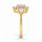My Store 4 18K gold ring featuring an oval fancy color diamond with heart-cut side stones in a side profile view.