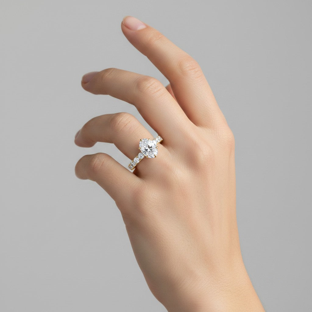 My Store 4 18K solid gold engagement ring set featuring an oval-cut lab-grown diamond and a pavé band on a hand.