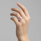 My Store 4 18K solid gold ring featuring an oval fancy pink diamond with heart-cut side diamonds on a woman's hand.