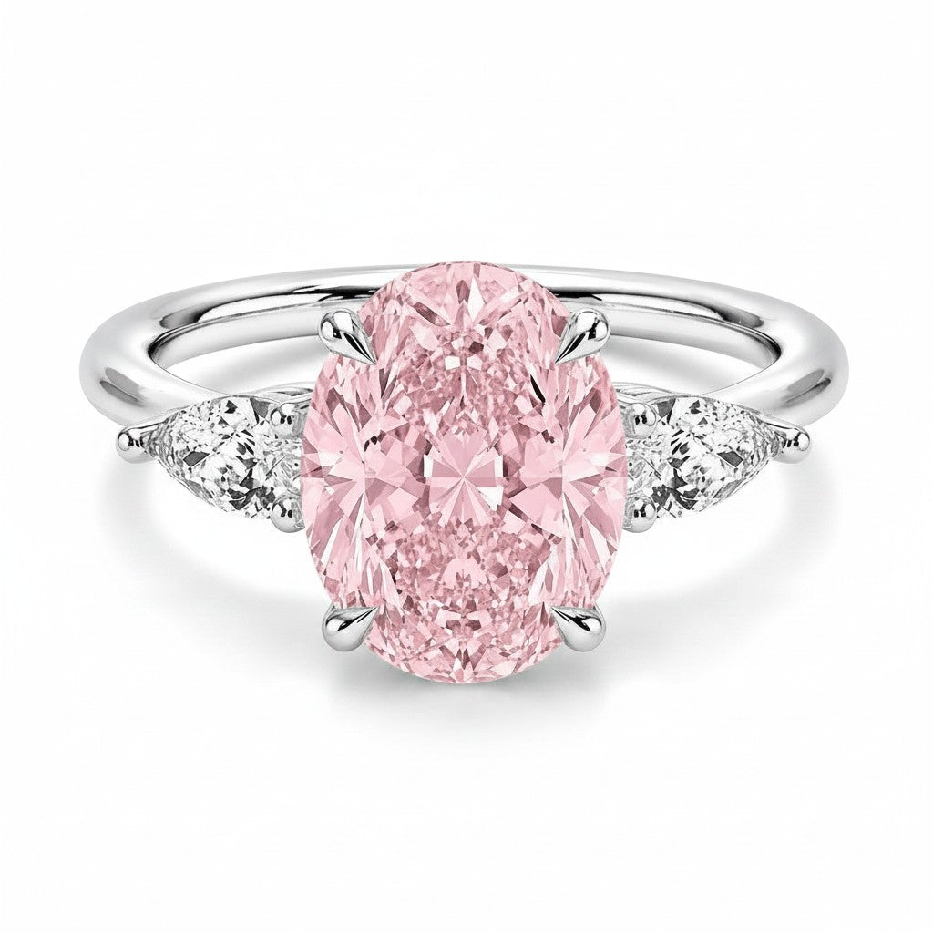 My Store 4 18K gold trilogy ring featuring a large oval pink lab-grown diamond flanked by two pear-cut side diamonds.