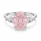 My Store 4 18K gold trilogy ring featuring a large oval pink lab-grown diamond flanked by two pear-cut side diamonds.