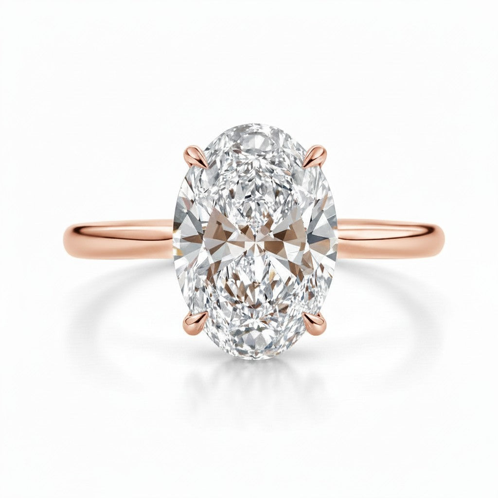 My Store 4 oval cut engagement ring with a brilliant center stone and four claw prongs on a polished rose gold band.