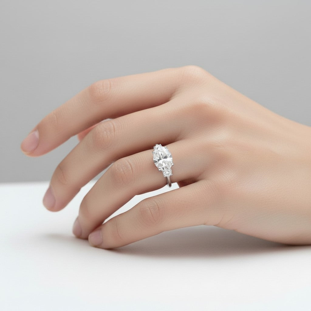 My Store 4 18K solid gold trilogy engagement ring featuring a central oval lab-grown diamond with oval side stones.