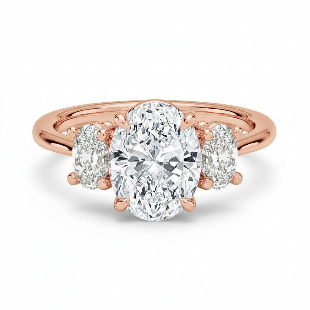 My Store 4 18K rose gold trilogy engagement ring featuring a large oval-cut lab diamond with two oval side stones.