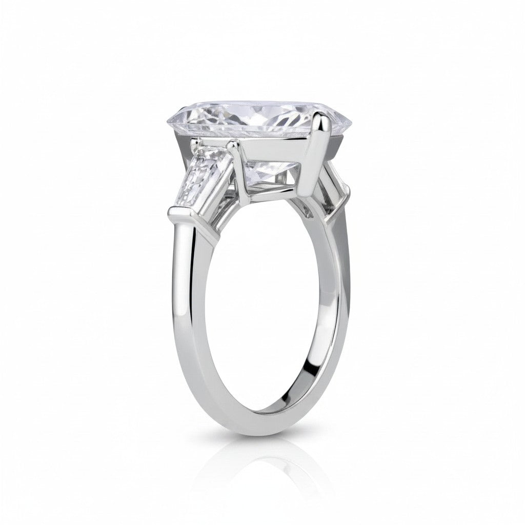 My Store 4 pear cut engagement ring with tapered baguette side stones in polished white gold, side profile view.