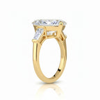 My Store 4 three-stone engagement ring with a pear-cut center diamond and tapered baguette side stones in yellow gold.