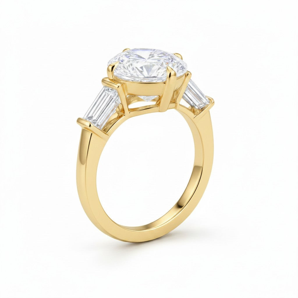 My Store 4 three-stone engagement ring with a pear-cut center diamond and tapered baguette side stones in yellow gold.