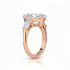 My Store 4 pear cut engagement ring with tapered baguette side stones in polished rose gold, side profile view.