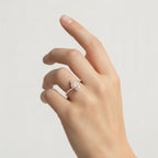 My Store 4 pear cut chevron pavé engagement ring in solid gold worn on a finger with a tiara-inspired silhouette