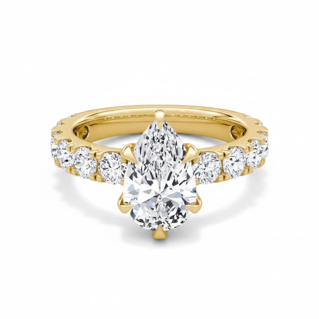 My Store 4 pear cut diamond engagement ring with a five-prong setting and shared-prong accent band in yellow gold.