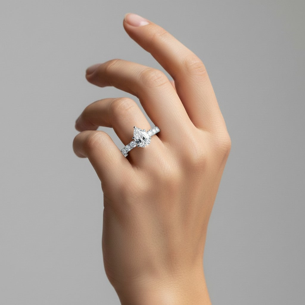 My Store 4 pear cut diamond engagement ring with shared-prong accent band on a woman's finger