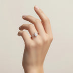 My Store 4 pear cut diamond engagement ring with station accent diamonds on a delicate yellow gold band worn on a hand